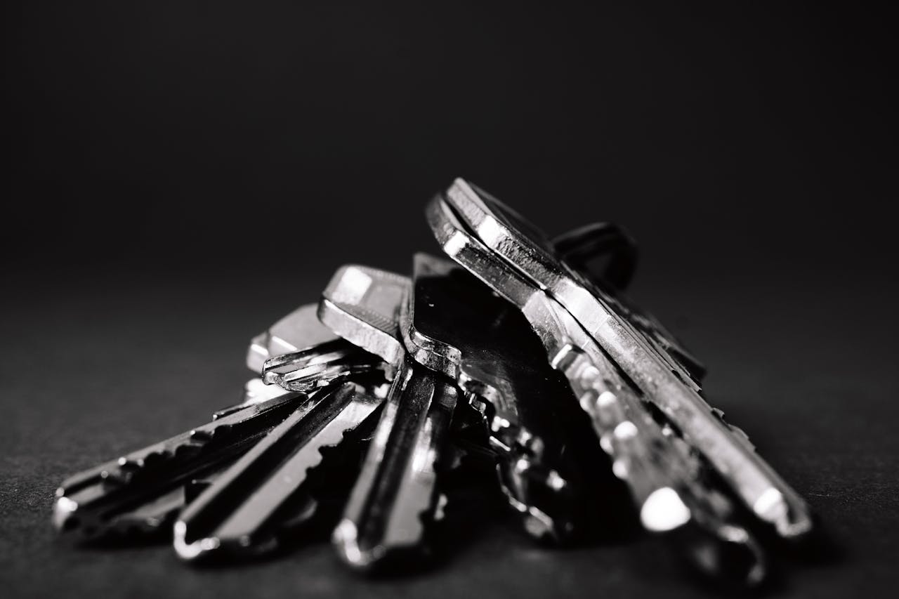 heros-img A close-up shot of a pile of metallic keys on a dark surface, emphasizing security and precision.